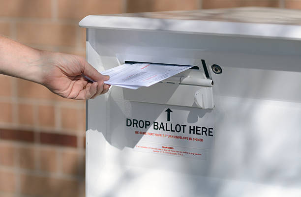 Early Voting Mail in Ballot Drop off Arvada, Colorado, USA - October 23, 2016:  Hand delivering ballots to Jefferson County Drop Off Ballot Box arcada stock pictures, royalty-free photos & images