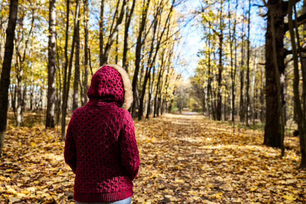 istock Woman in autumn park 616880380