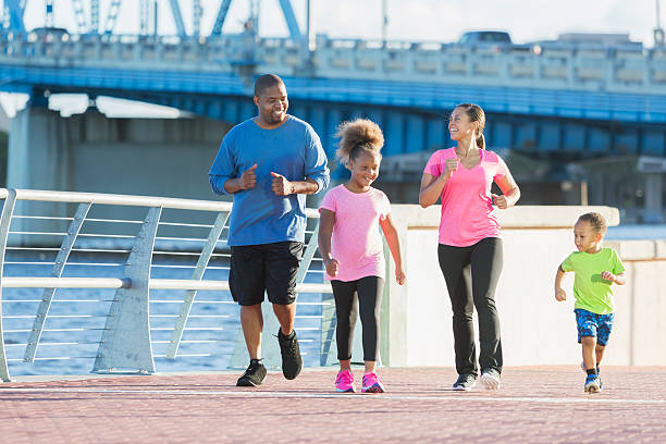 istock Black family staying fit, power walking on waterfront 616883144