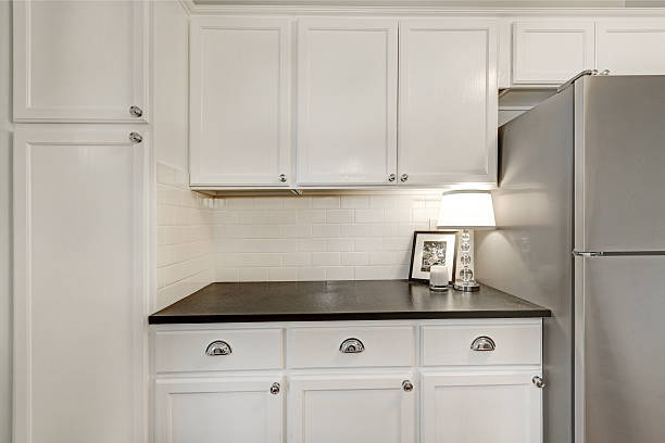 istock White kitchen storage combination and steel appliances 616883342