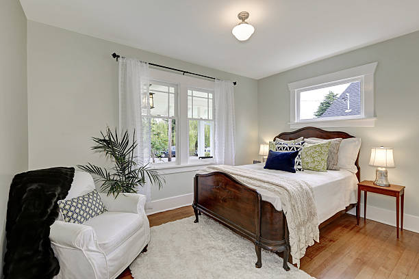 istock White bedroom interior with vintage wooden bed 616883428