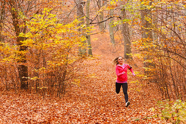 istock Young sporty girl doing exercises in forest. 616883456