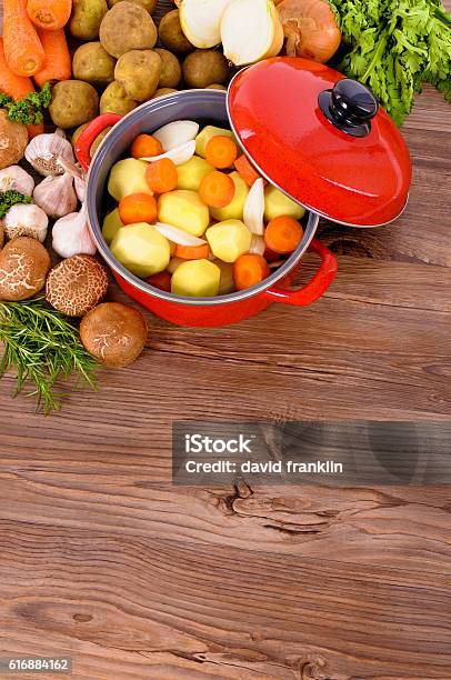 Red Casserole Dish With Winter Vegetables And Herbs Stock Photo - Download Image Now