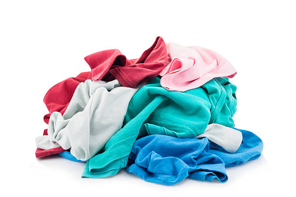 istock pile of dirty laundry Isolated on white. 616884794