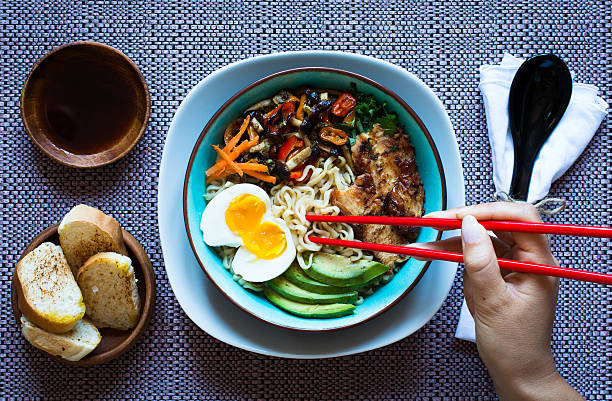 istock Japanese noodles bowl with chicken, carrots, avocado 616884820