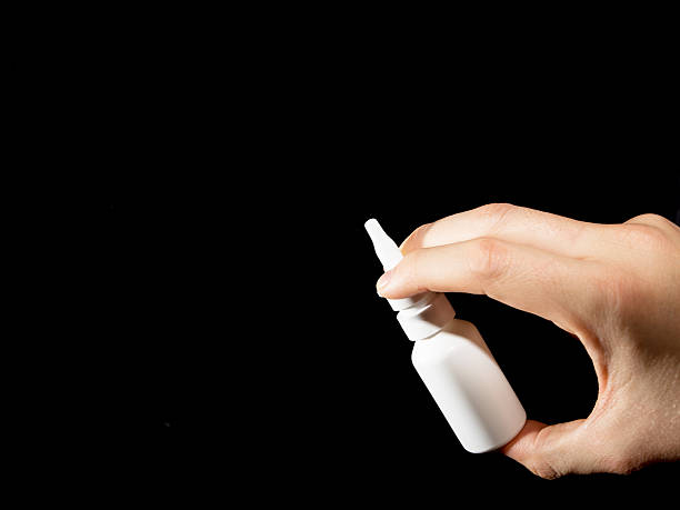 istock White bottle of nasal spray on black 616884990