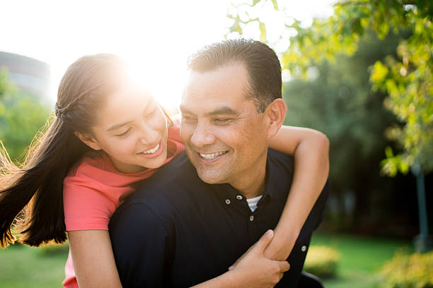 istock Affectionate latin father and teen daughter smiling 616885136