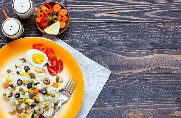 istock Vegetarian fresh salad with white rice  on wooden background 616885338
