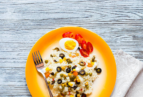 istock Vegetarian fresh salad with white rice  on wooden background 616885648