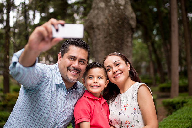 istock Latin father taking selfie with wife and son 616887804
