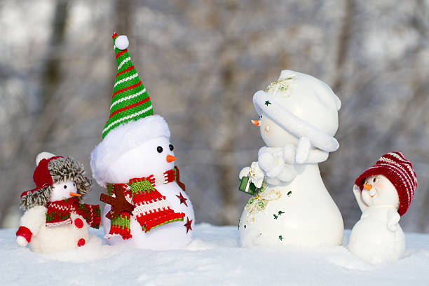 istock four snowman in the snow looking at each other 616888008
