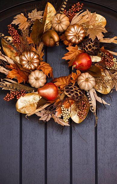 istock Ornate fall wreath with gold pumpkins hanging on front door 616888816