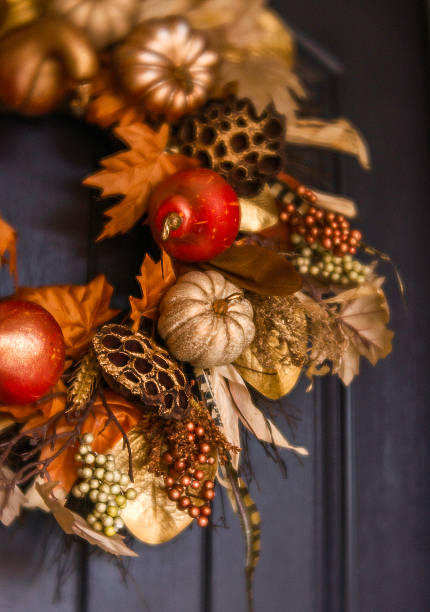 istock Ornate fall wreath with gold pumpkins hanging on front door 616888918