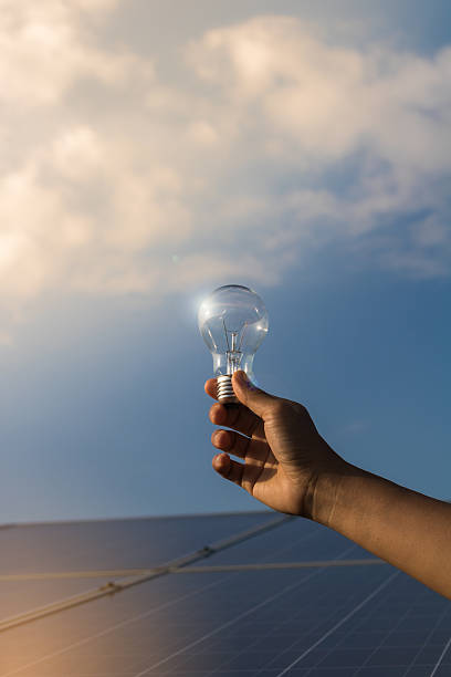 istock women holding the bulb on solar panels 616888956