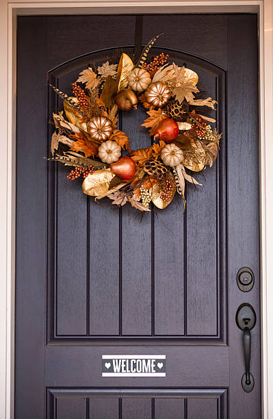 istock Ornate fall wreath with gold pumpkins hanging on front door 616888962