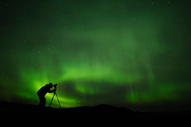 istock silhouette of photographer shooting aurora 616889002