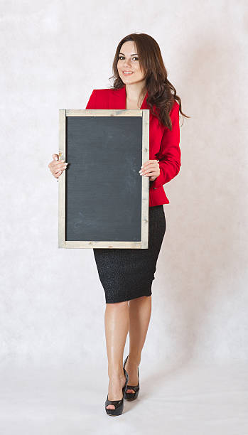 istock Young woman with a black chalk board 616889784