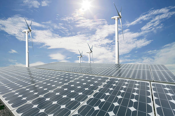 istock Solar panels and wind turbine with blue sky background. 616889972