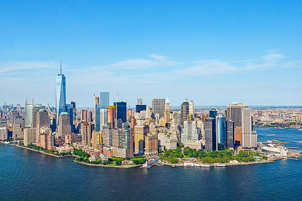 Manhattan, New York Shot from a helicopter, a view of beautiful Manhattan, New York on a clear blue sky summer day. New York City is a large American City in the State of New York. lower manhattan stock pictures, royalty-free photos & images