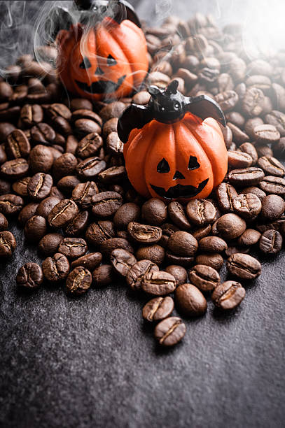 istock Halloween pumpkin decoration with coffee beans on dark background 616890758