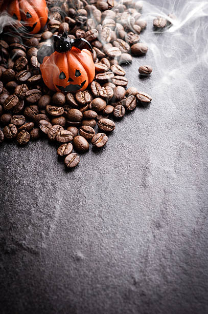 istock Halloween pumpkin decoration with coffee beans on dark background 616890766