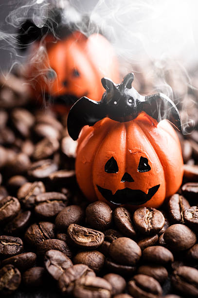 istock Halloween pumpkin decoration with coffee beans on dark background 616890794