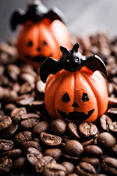 istock Halloween pumpkin decoration with coffee beans on dark background 616890800