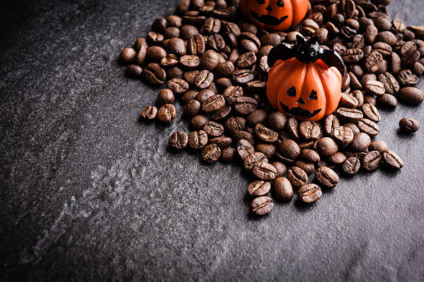 istock Halloween pumpkin decoration with coffee beans on dark background 616890810