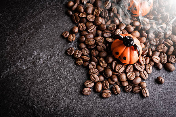 istock Halloween pumpkin decoration with coffee beans on dark background 616890818