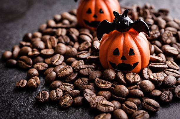 istock Halloween pumpkin decoration with coffee beans on dark background 616890838