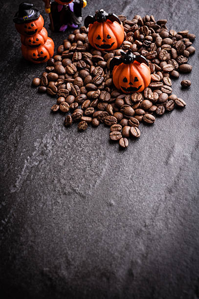 istock Halloween pumpkin decoration with coffee beans on dark background 616890840