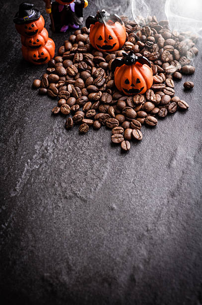 istock Halloween pumpkin decoration with coffee beans on dark background 616890864