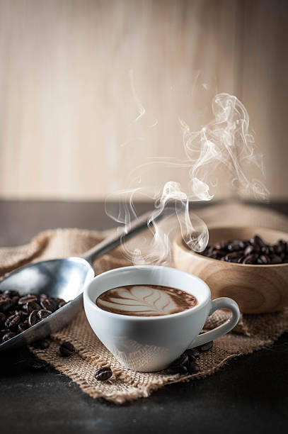 istock Coffee cup and coffee bean on black stone background 616890938