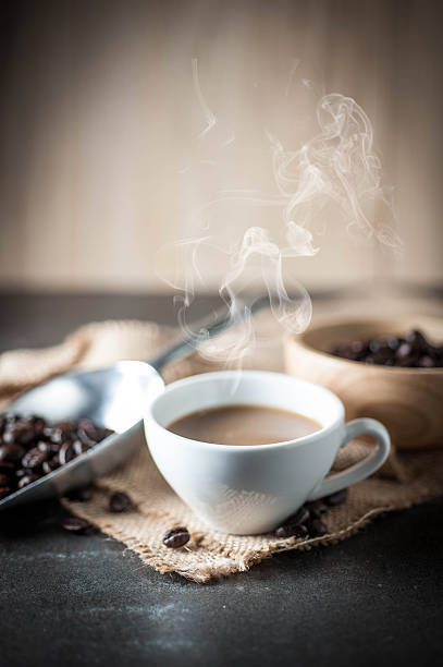 istock Coffee cup and coffee bean on black stone background 616891008