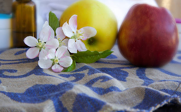 istock Apple blossoms with green leaves 616891308