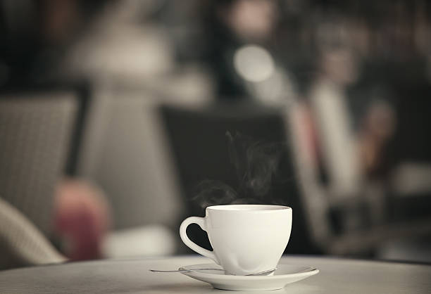 istock White cup of coffee at the summer cafe table 616891486