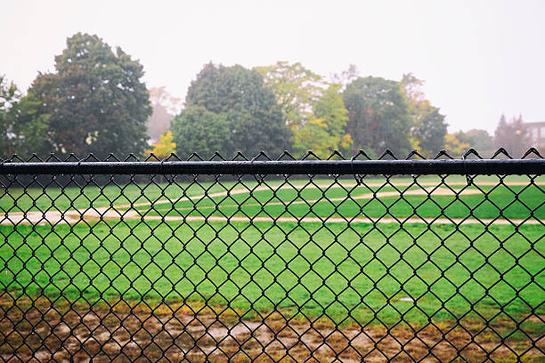 istock rain on an empty sports field 616891634