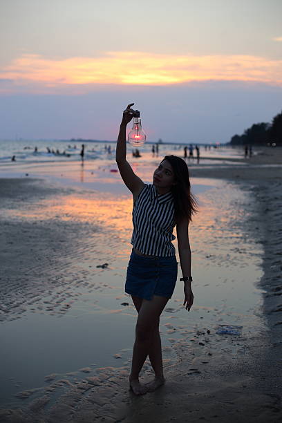 istock Woman holds the electric light bulb 616892392