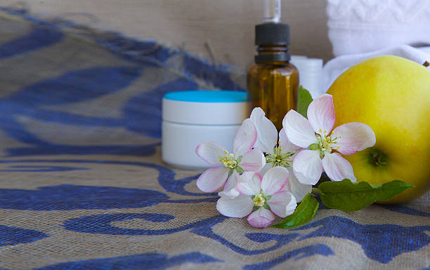 istock Apple blossoms with green leaves 616892984