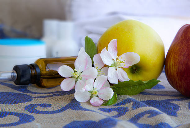 istock Apple blossoms with green leaves 616893046