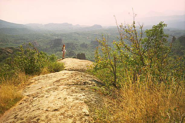 istock Woman standing on Belogradchik rocks 616893202