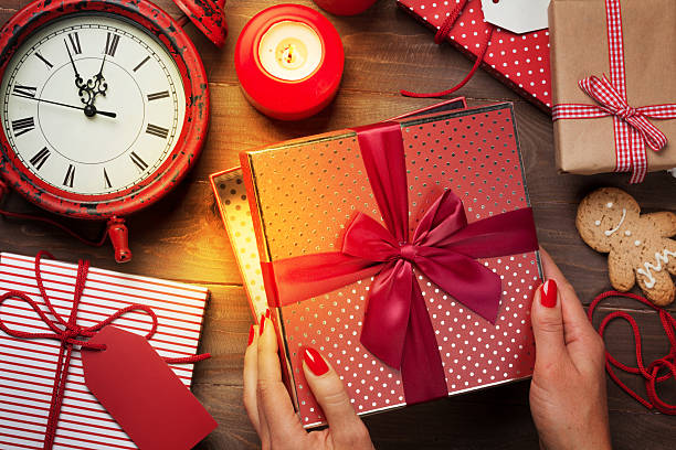 istock Female hands opening xmas gift 616894728