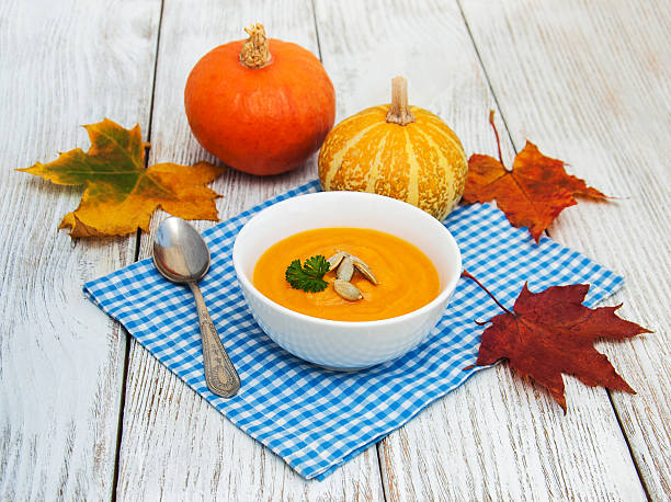 istock Pumpkin soup with fresh pumpkins 616894878
