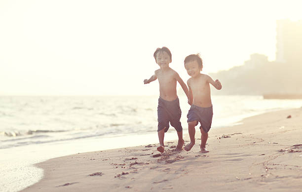 istock Children playing on the beach 616895120