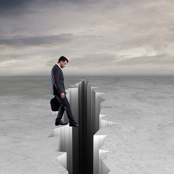 istock Businessman about to step into crack 616895556