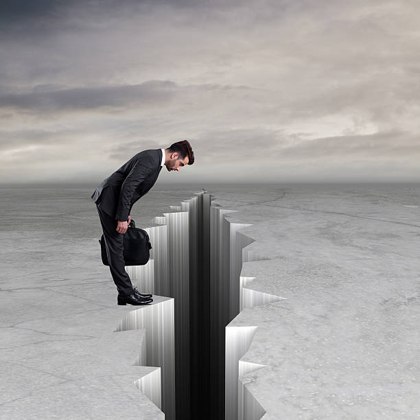 istock Curious businessman looking into cracked 616895740