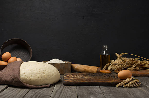 istock Dough with ingredients for cooking dough on wooden kitchen table 616897752