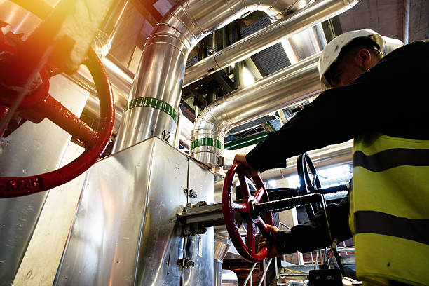 factory worker turning valve - valve chemical plant oil industry imagens e fotografias de stock