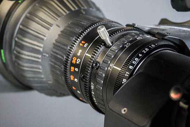 istock Video camera lens in TV studio - focus on aperture 616902014