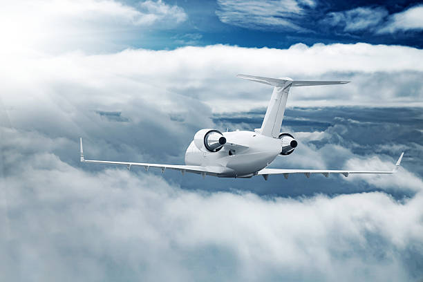 istock White airplane flying higher clouds at daytime 616902484